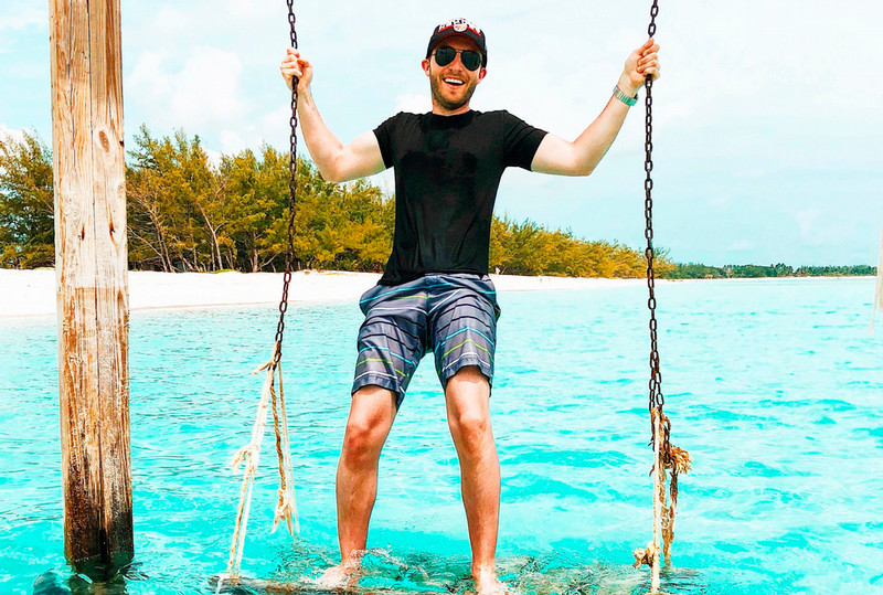 Nicolo Bates poses on a swing over the ocean