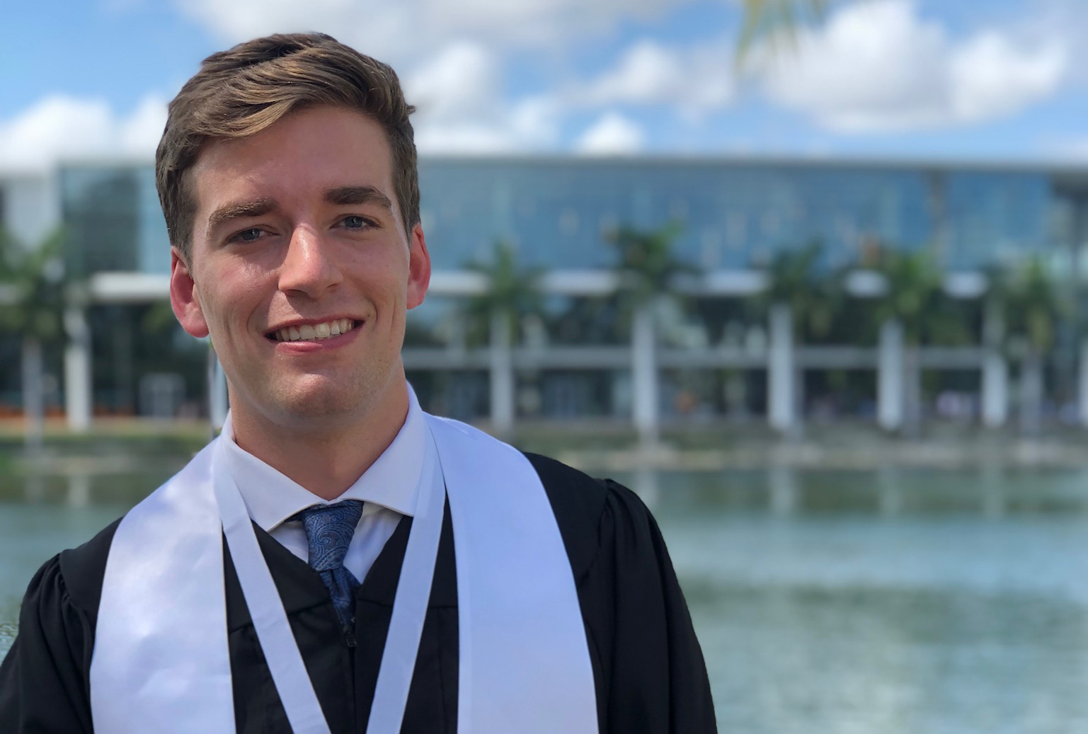 Conrick Gallagher poses in his graduation gown