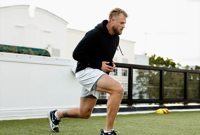 PAC athlete student doing lunges before a workout