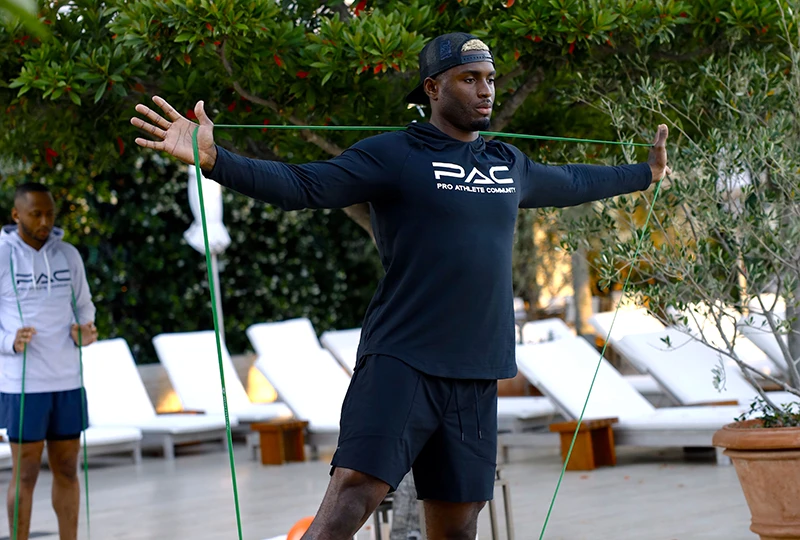 PAC student stretching with band before a workouy