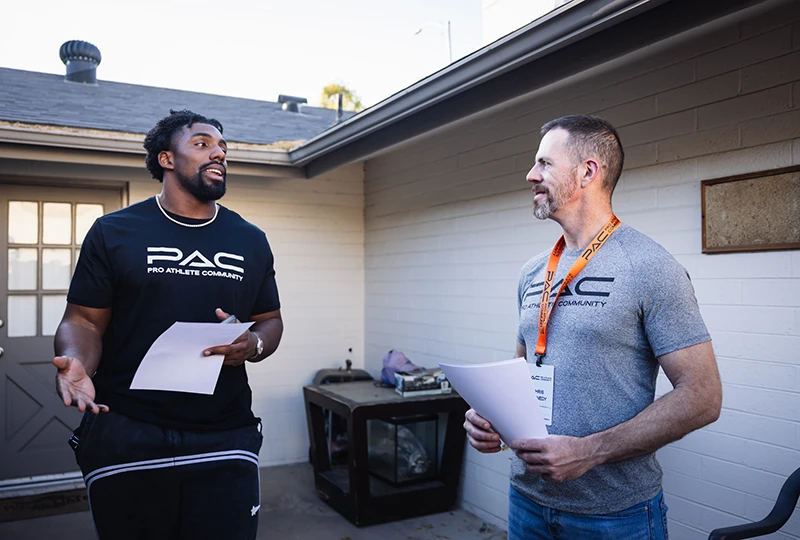 student and mentor discussing real estate ventures on site