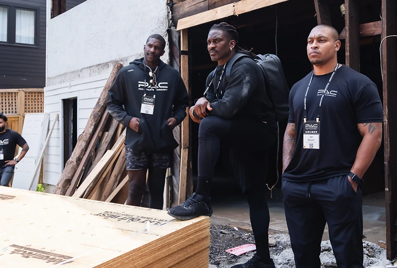 three men at a construction site for a new home