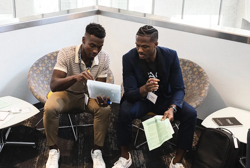 two students prepare for their presentation on negotiations