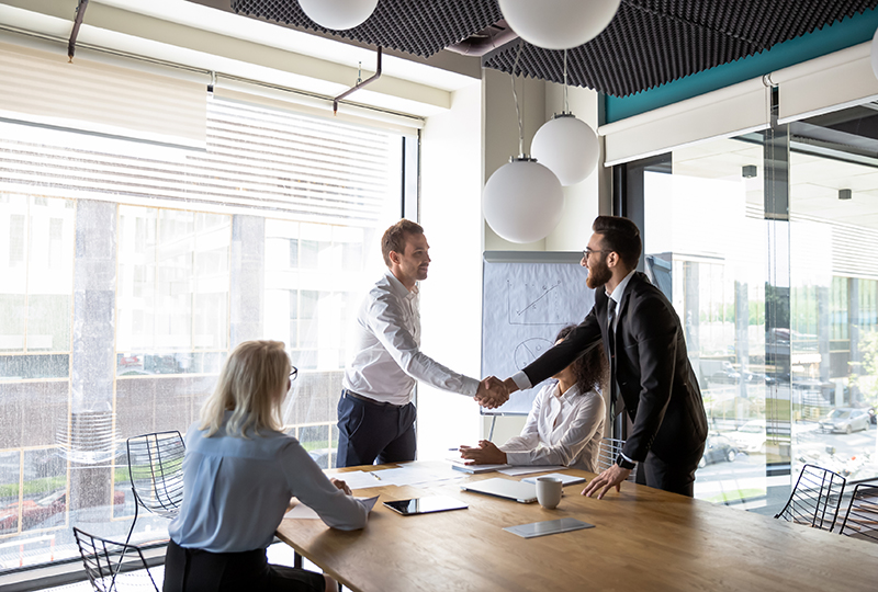 group of people shaking hands in office