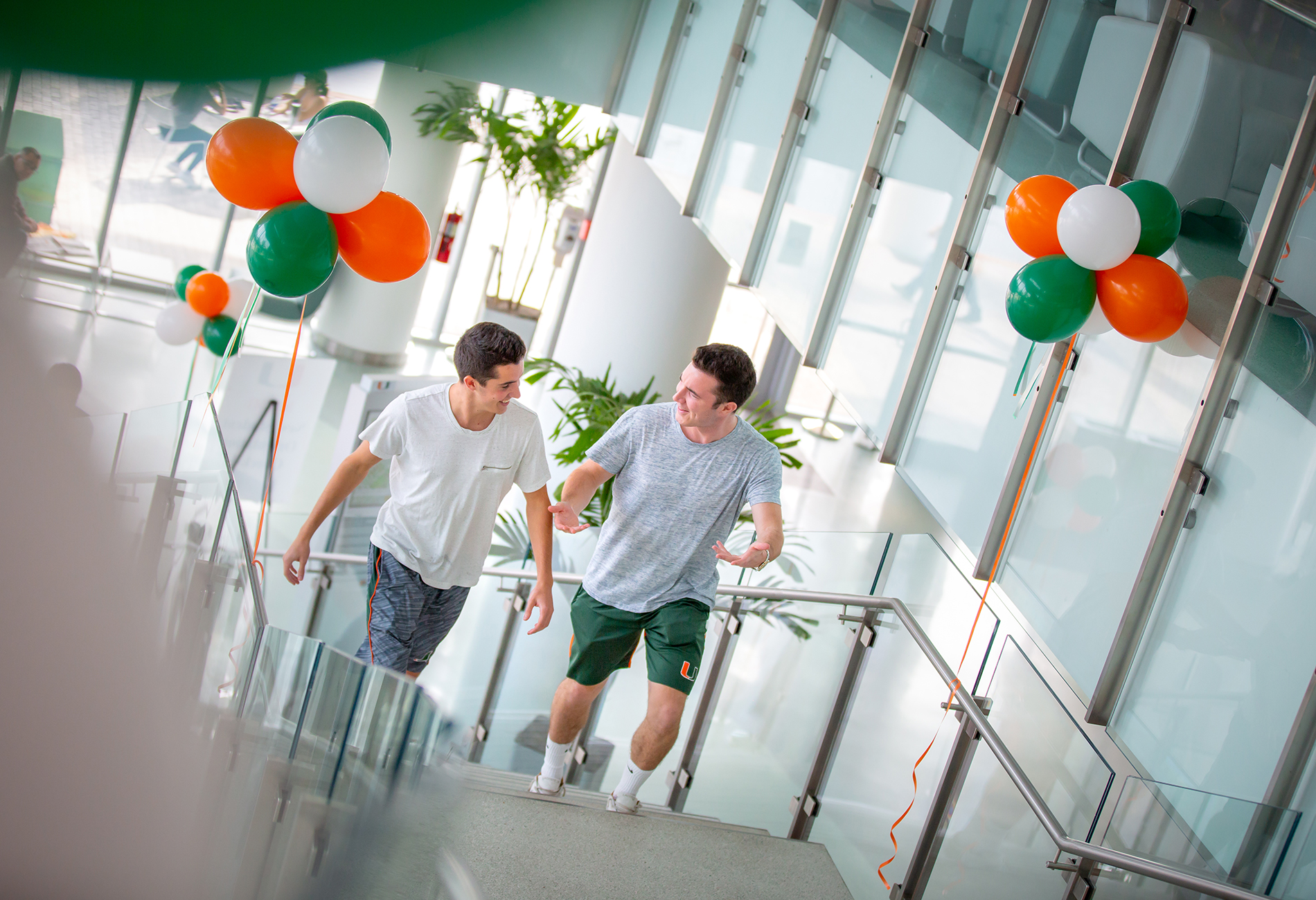 Two students walking up the stairs at the University of Miami student center.