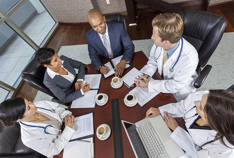 health care professionals sitting at a conference table