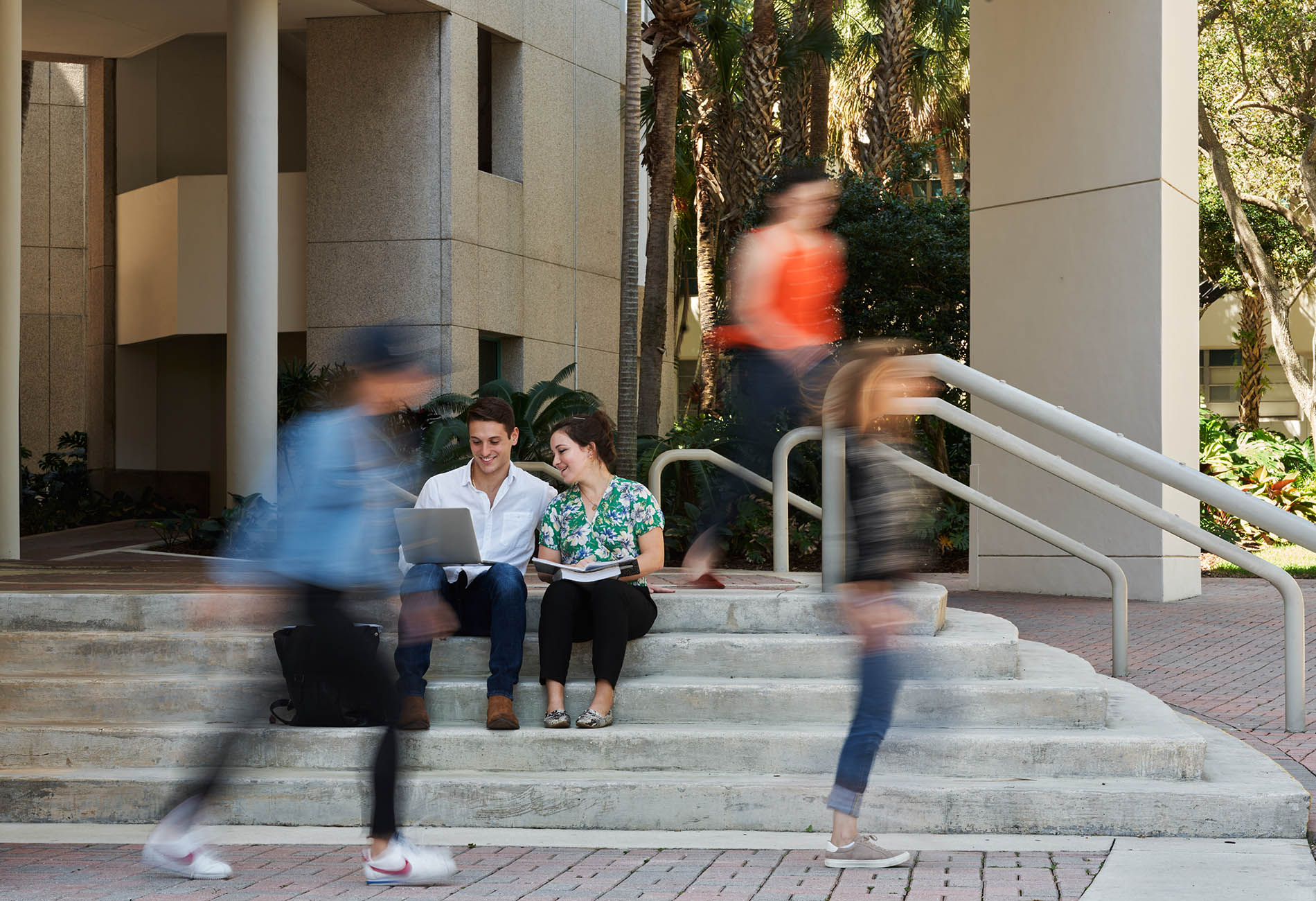 students using laptop outside