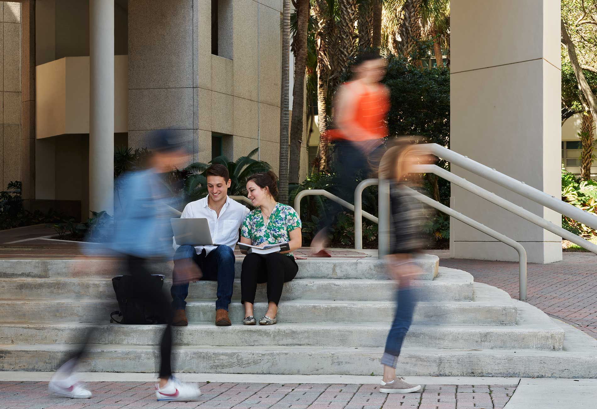 Students sit on steps