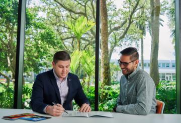 Two male students meet to discuss GEMBA