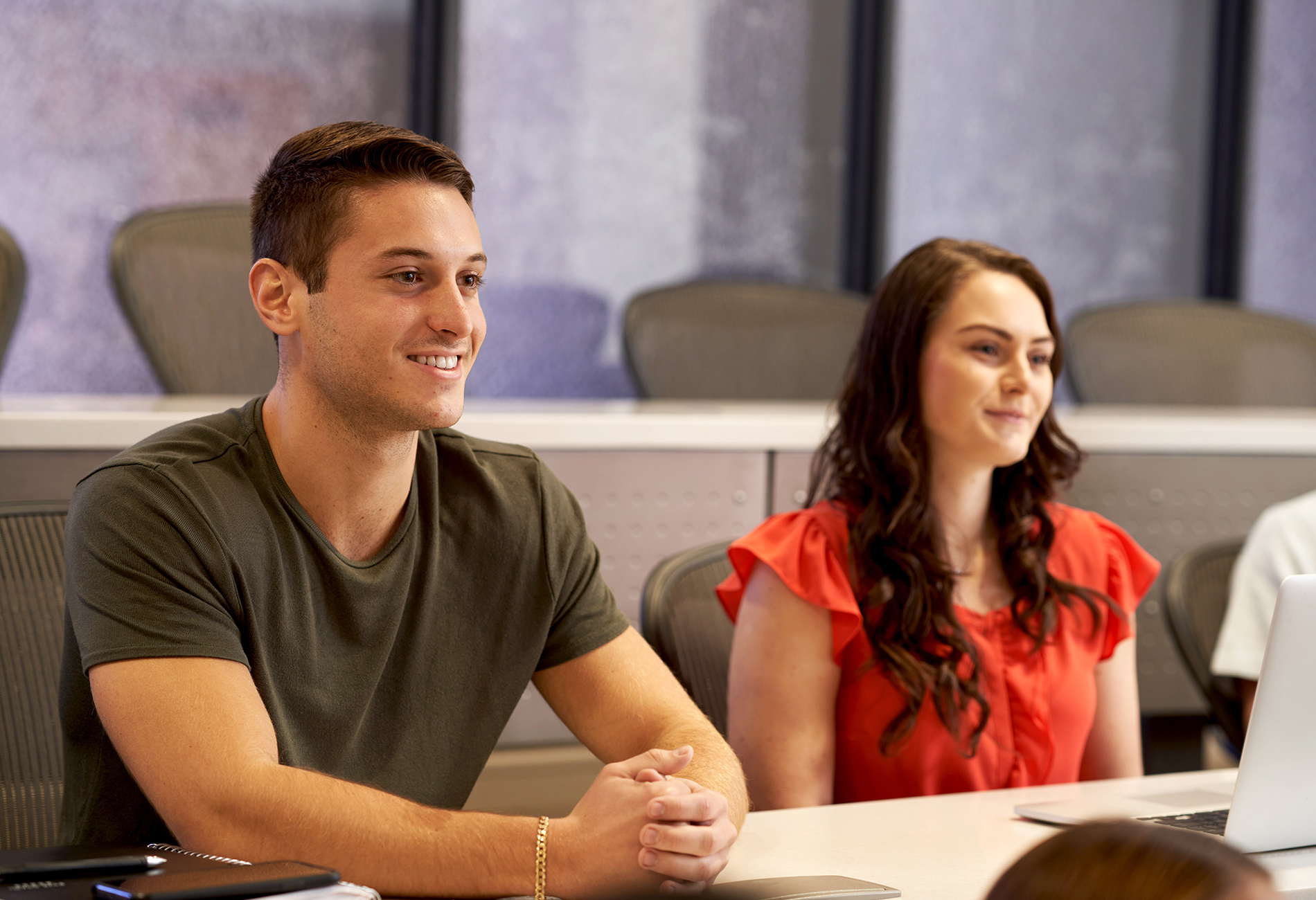 A male and a female student sit in a classroom