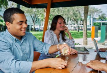 students on campus drinking coffee