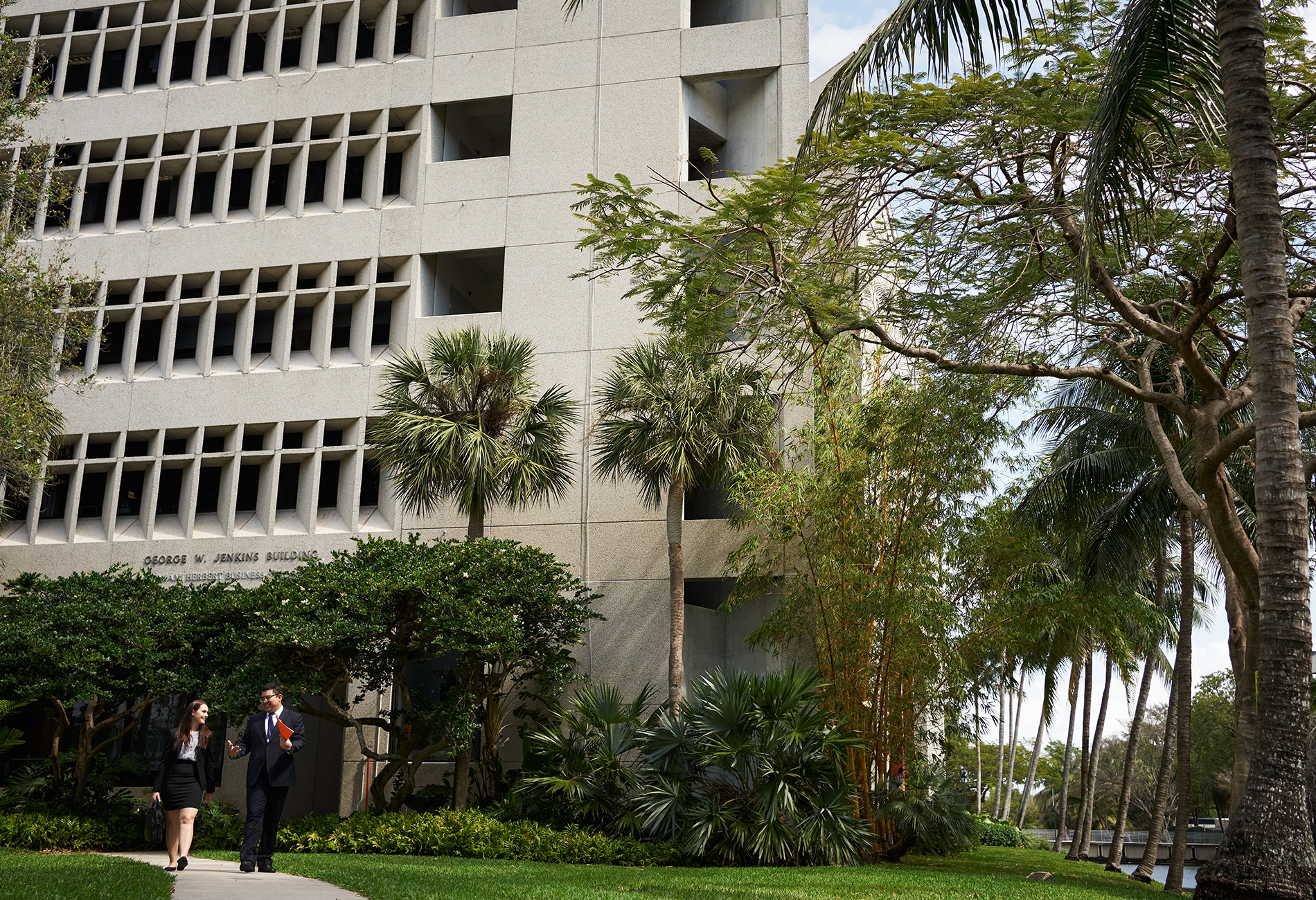 Professional MBA students walk together on campus.