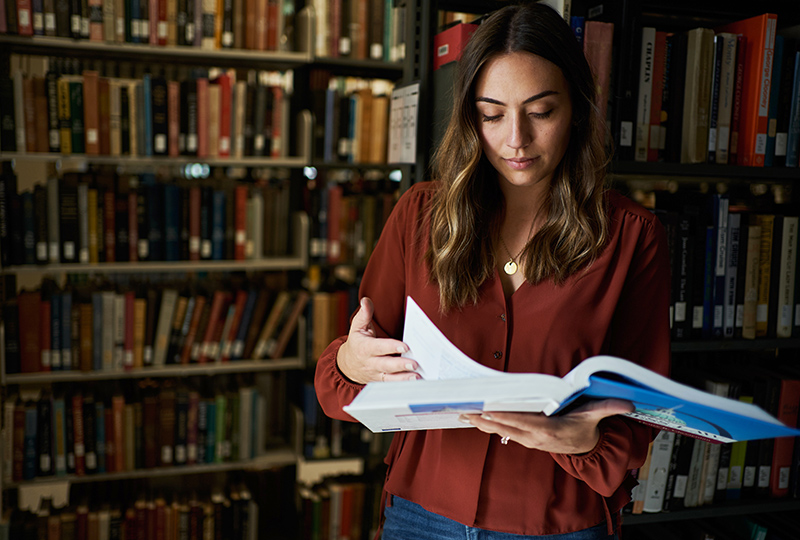 Student in library with book