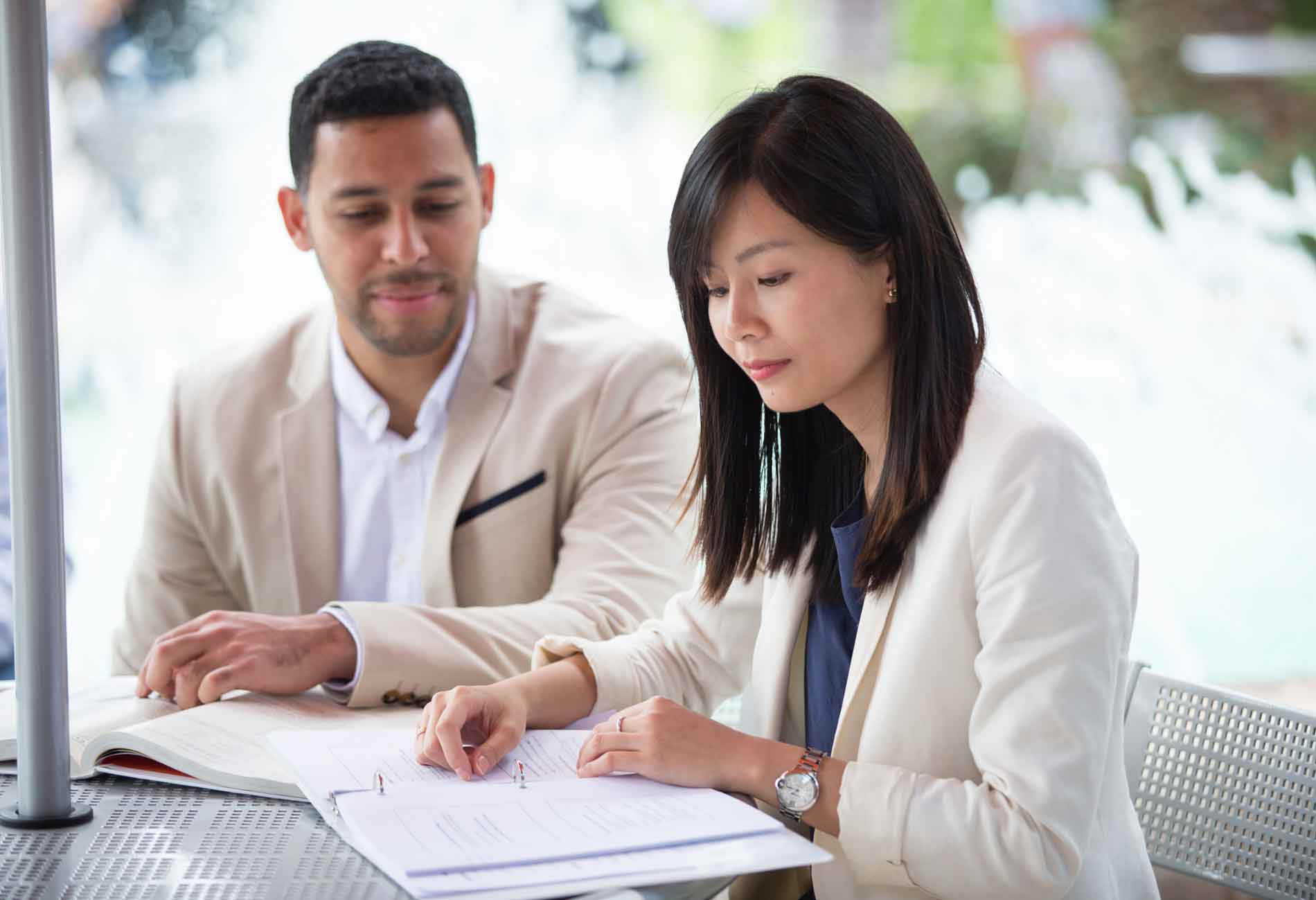 Two doctoral students study on campus