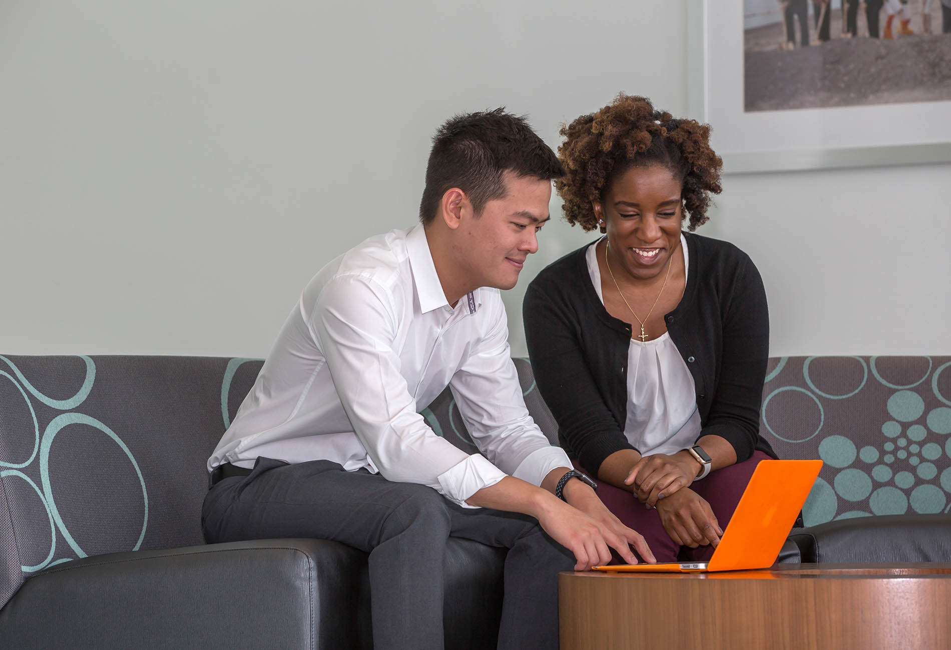 Graduate students working on a laptop