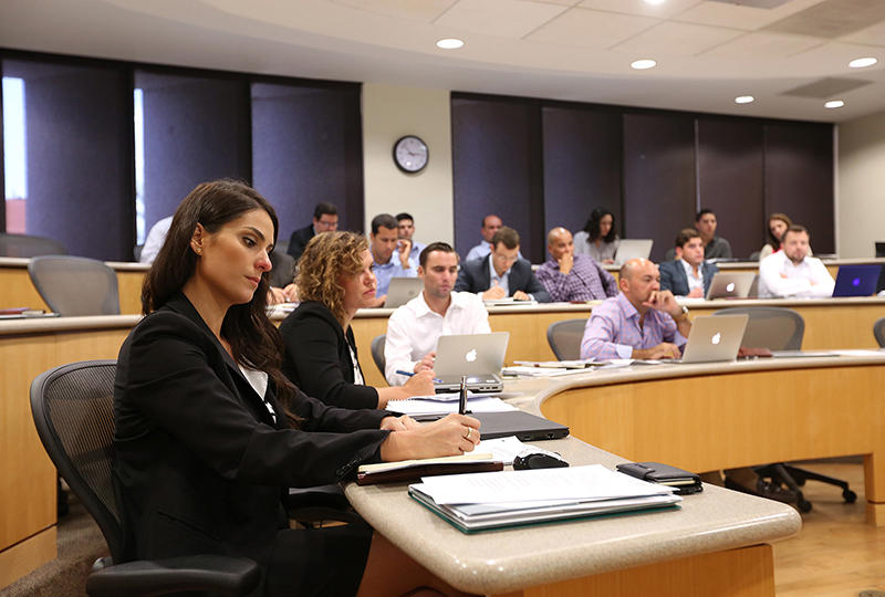 Students sit in a classroom taking notes.