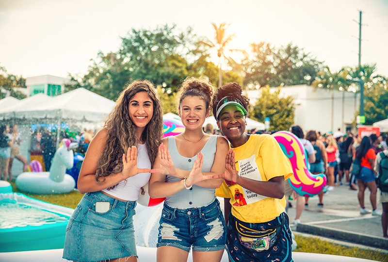 Three students at a pool party