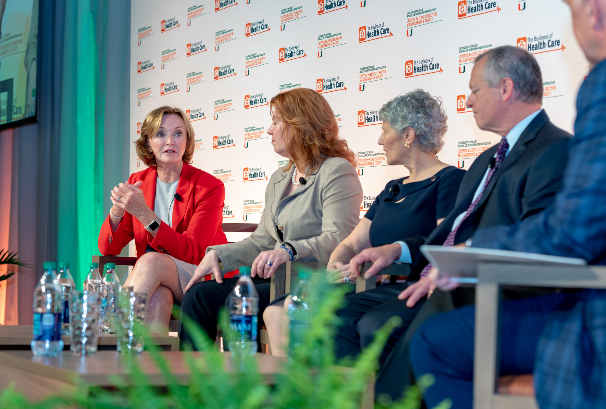 A panel of people speaking at an event.