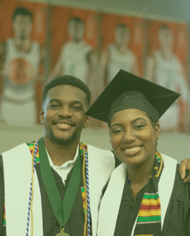 2 graduates with their robes on