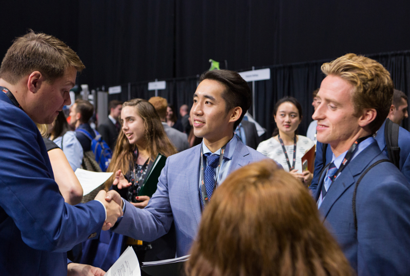 Students meeting employers at career expo