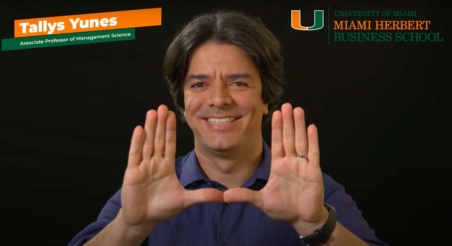 Tallys Yunes smiles and holds up his hands in a "U" shape.