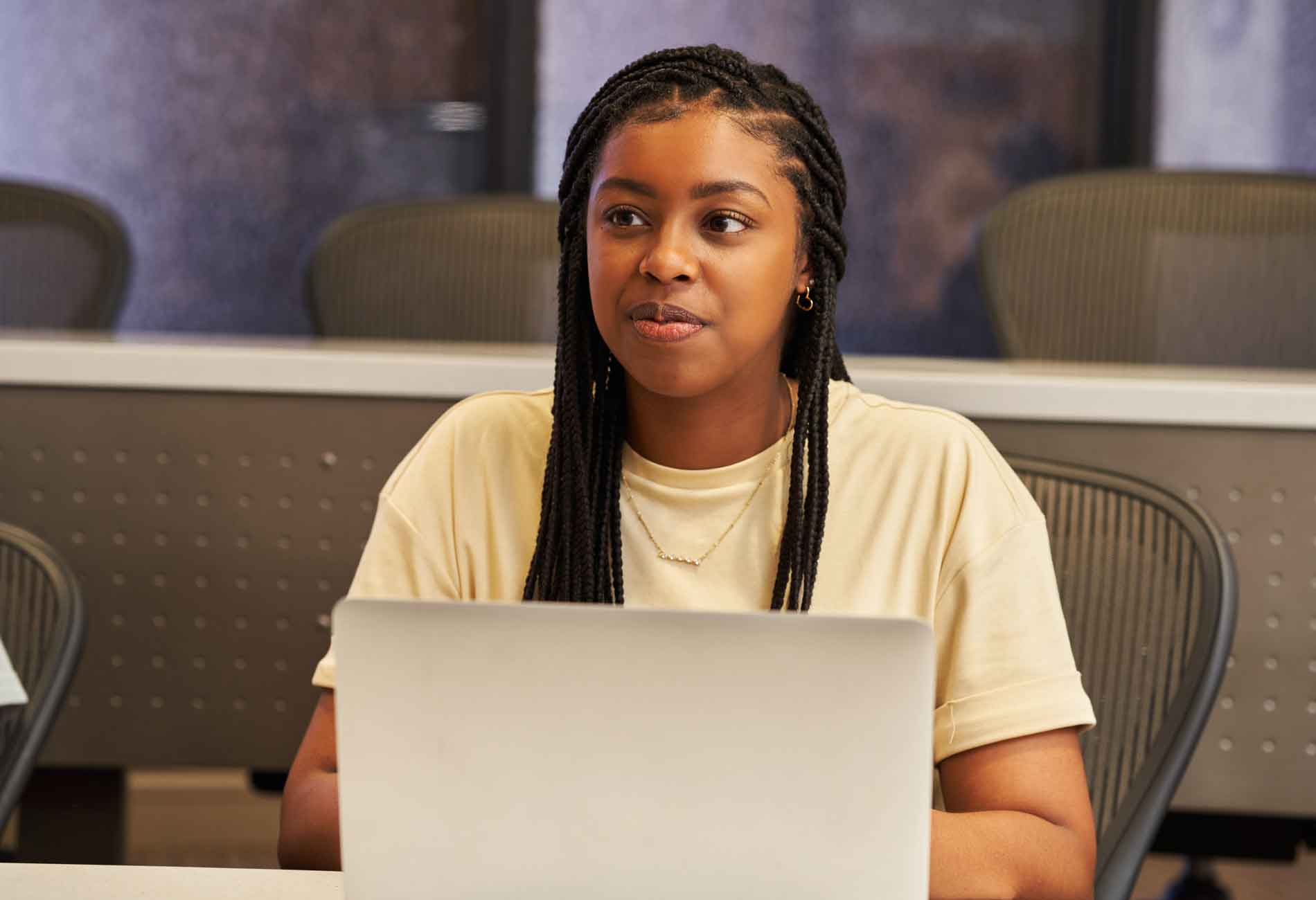 Student sitting in front of an open laptop.