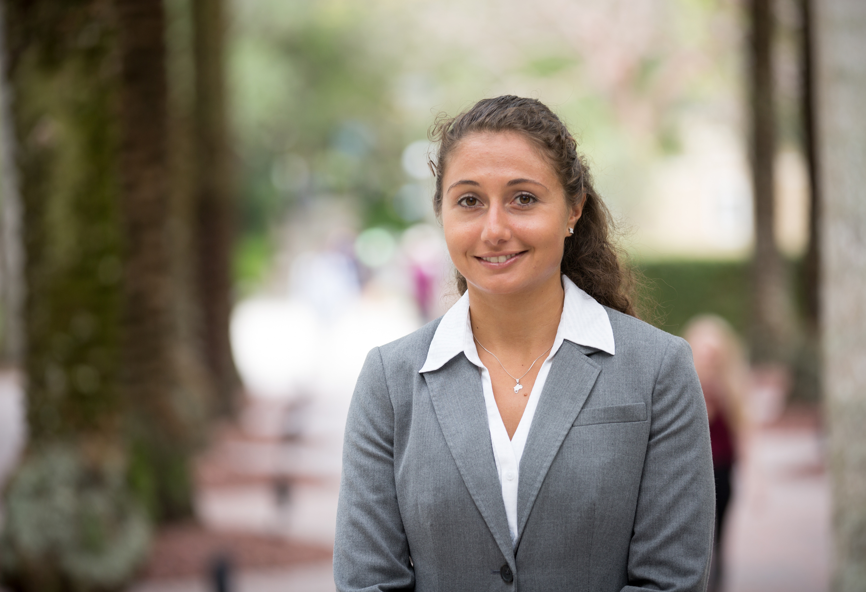 Close up of a female student standing outside.