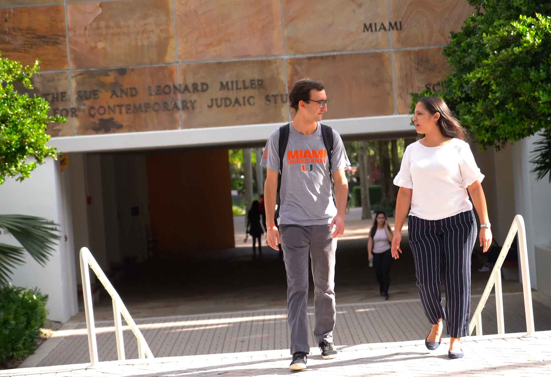 Two students walking on campus.