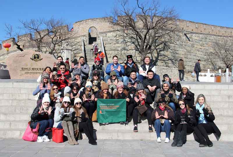 Students pose on a set of stairs in China.