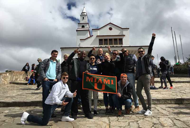 Students pose for a photo in front of a church in Colombia.